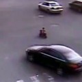 Chinese toddler rides scooter through intersection Chinese toddler rides scooter through intersection