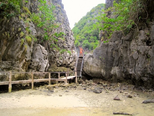 Swimming through the waters to the makeshift rope ladder attached to the rocks, up and over leads you down this path across the island to The Beach.