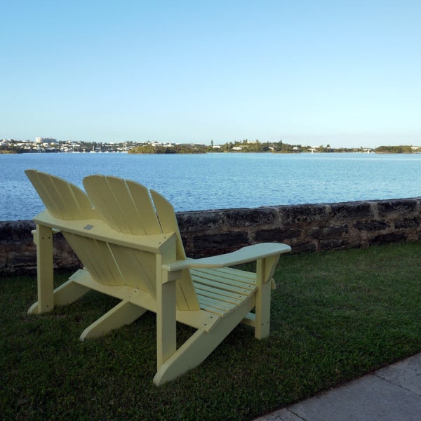 Adirondack chairs are poised for a pleasant harbour view.