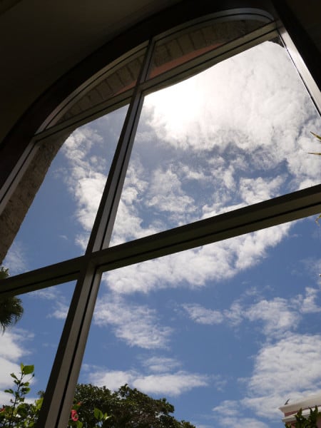 Large windows at The Heritage Court offer lovely views of the garden and sky.