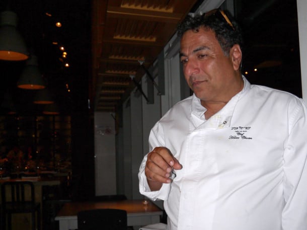 Chef Haim Cohen steps away from the stove and chats with dinner guests at his Yaffo - Tel Aviv restaurant