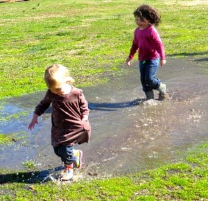 Children splashing in a puddle at the Farmer’s Market