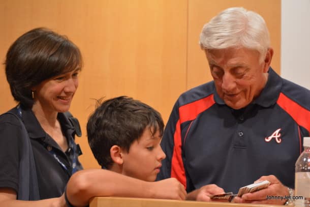 Phil Niekro looking at baseball cards after his Q&A for Tauck Events in Cooperstown