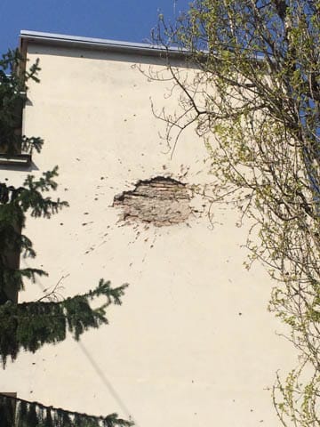 One of many mortar marks that scar the buildings of Sarajevo