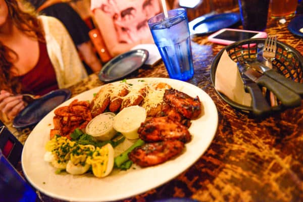 Swag Sampler plate: spicy shrimp boil, chicken wings, fried green tomatoes, and Creole spiced deviled eggs at Dinosaur Bar-B-Que