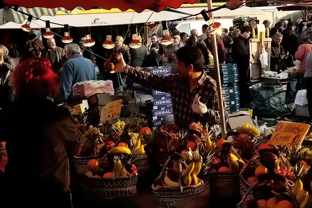 A vendor at the fish market selling fresh fruit