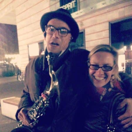 Jenny and the jazz saxophonist playing outside of our hotel