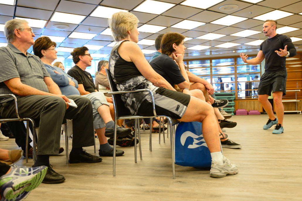 Guests listen to a presentation about nutrition and weight loss in the fitness center