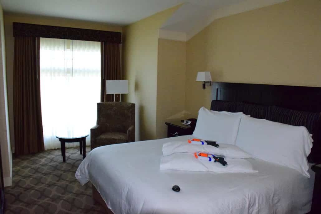 Bed with Nerf guns and extra pillows