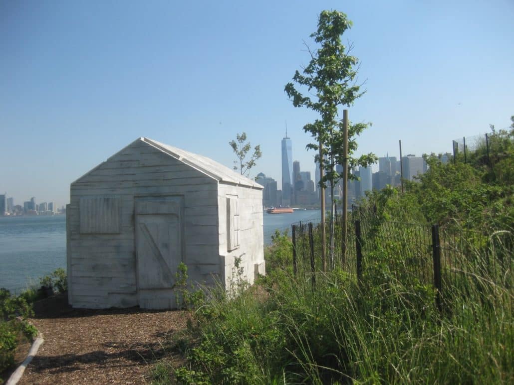 From Discovery Hill, the "Cabin" sculpture cast with Manhattan in background