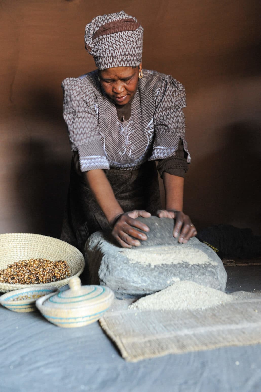 Basotho woman demonstrates the process of making beer