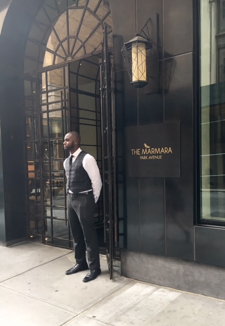 One of the friendly doormen on the sidewalk outside of the hotel
