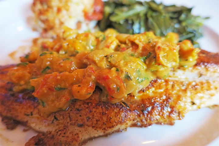 Grilled catfish served with crawfish etouffee and collared greens from Brown Dog Eatery, Carrollton
