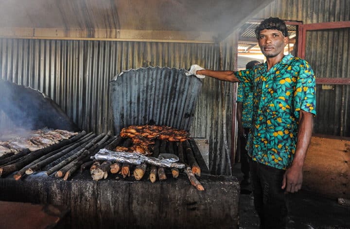 Cooking chicken over pimento wood at Scotchies in Montego Bay