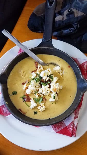 Cheddar beer soup topped with bacon and popcorn at Red Fox Saloon