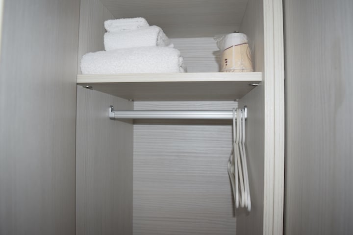 Inside a locker: towels, hangers and cups
