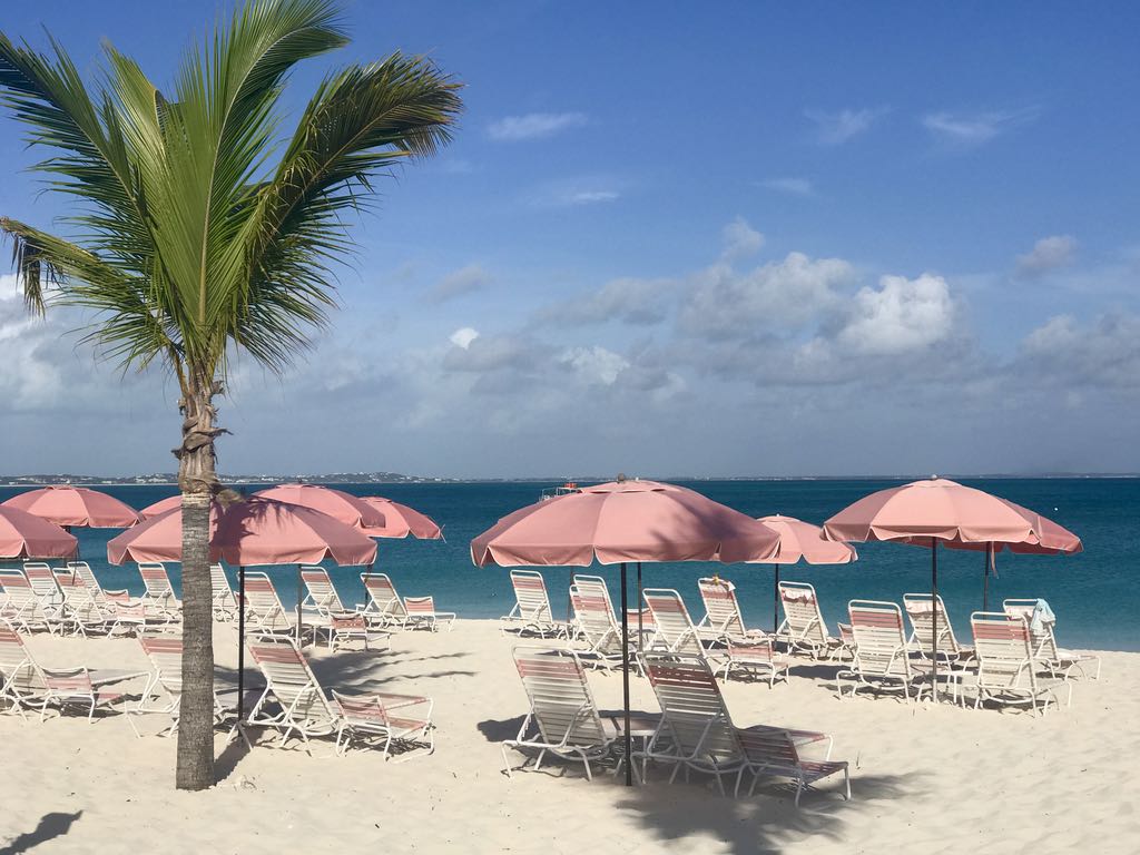 Pink umbrellas on the beach at Ocean Club Resorts