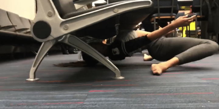 Guinness limbo record holder limbos under airport seat