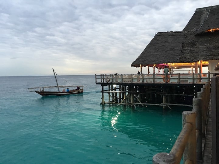 A small boat passes Ocean Blue restaurant