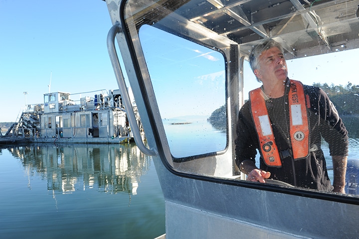 Penn Cove Shellfish Operations Manager Tim Jones taking the skiff out on Penn Cove to check on the shellfish