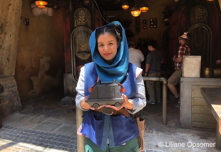 A cast member selling a popcorn holder