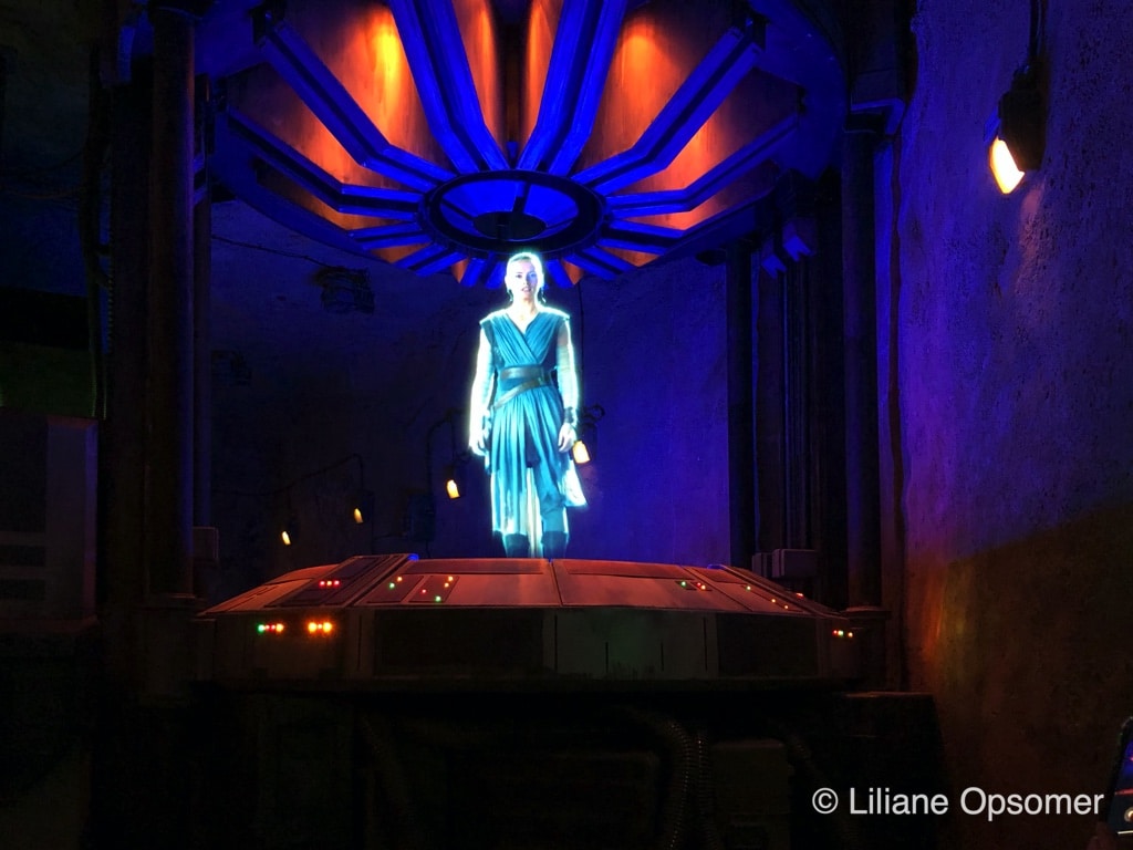 Rey appears in a holo-transmission to recruit riders